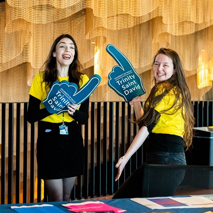 Student ambassadors with UWTSD branded foam fingers