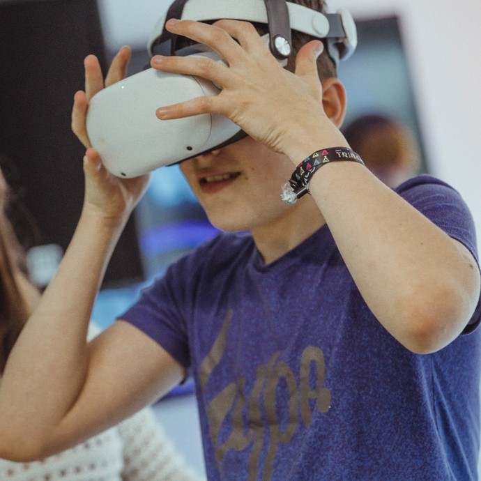 A boy wears a virtual reality headset.