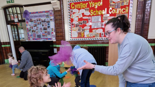 A child and adult playing with scarves