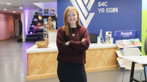 image of Manon John standing in front of yr Egin's reception 