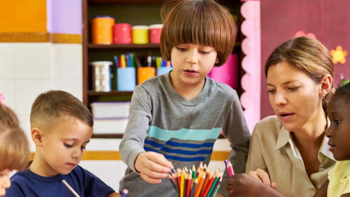 Children sitting in classroom with teacher