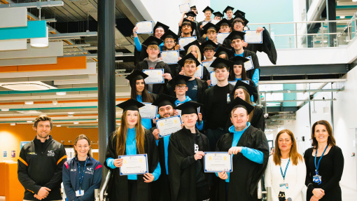 a group shot of the students in their cap and gown 