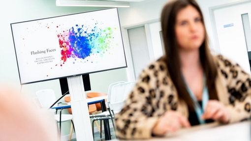 an image of a student blurred sitting in front of a screen