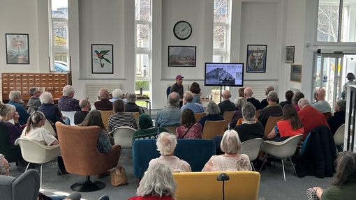 DR Rod Bale sitting at the front of the room with large audience listening to his talk