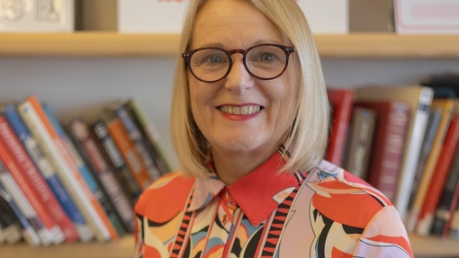 Woman with glasses smiling at camera