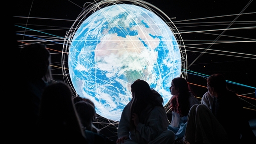Student looking at an interactive globe