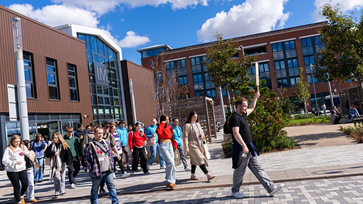 students walking outside the IQ building in Swansea