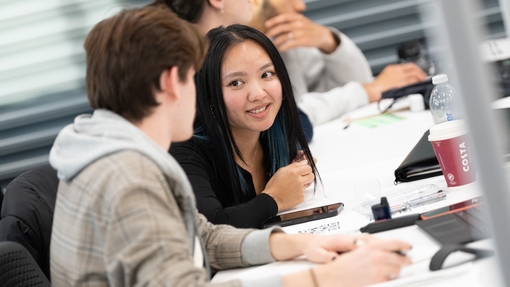 Two students chatting while in class