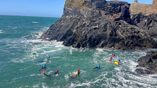 Students coasteering and swimming in the sea - landscape