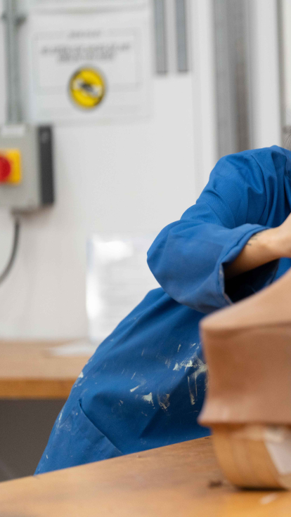 Student sculpting a prototype automotive car in class