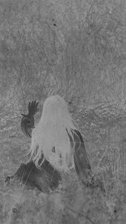 a film style photograph with a person walking through grass