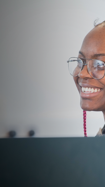 Student working at a computer in a classroom.