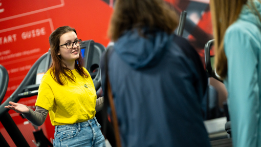 Student ambassador giving tour of gym in Carmarthen