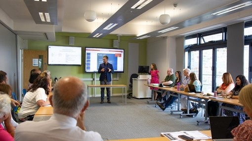 A man giving a presentation to the meeting.