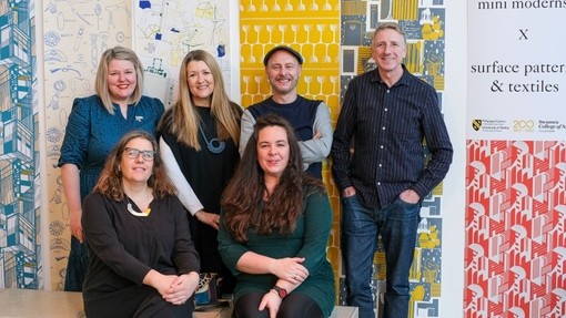 Keith Stephenson and Mark Hampshire from Mini Moderns smile alongside members of the Surface Pattern and Textiles teaching staff.