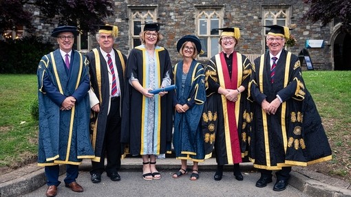 The Reverend Beti Wyn James with Dr Lowri Lloyd and other senior figures from the University, all in formal academic dress.