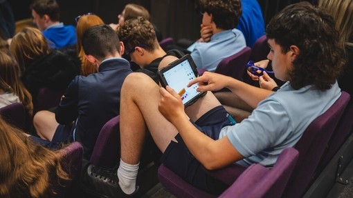 Person yn ei arddegau yn defnyddio iPad yn rhan o weithgarwch dosbarth.