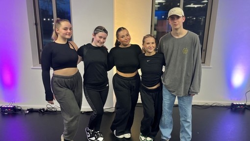 A group of students in a dance studio after a workshop