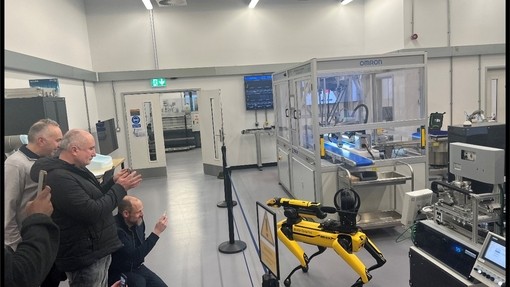 Belron representatives looking at a robot at UWTSD