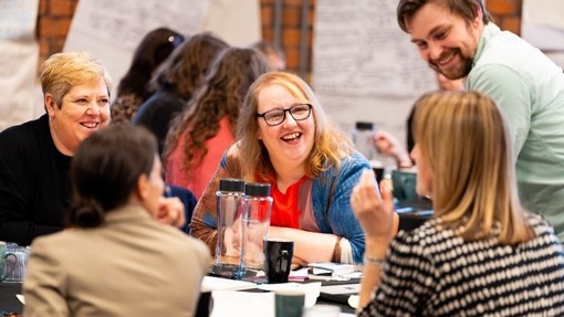 Teachers discussing around a table at the launch of the phase 3 of Camau i'r Dyfodol