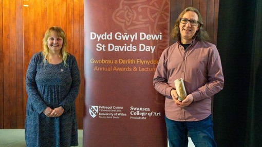 An image of Martin Cramping and Gwenllian Beynon next to a pop up advertising the St Davids Day lecture and awards event