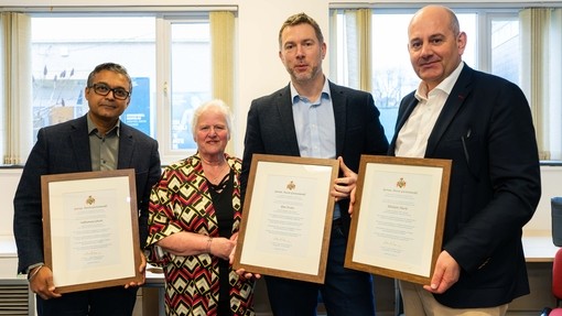 Image of Prof Wendy Dearing presenting ceriticiates toDr Subhamay Ghosh, Hywel Dda University Health Board, and Rhidian Hurle and Ifan Evans of Digital Health and Care Wales
