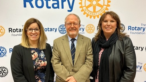 A photo of Lowri Harris, Andrew Edwards & Sarah Loxdale standing in front of a Rotary Branded stall