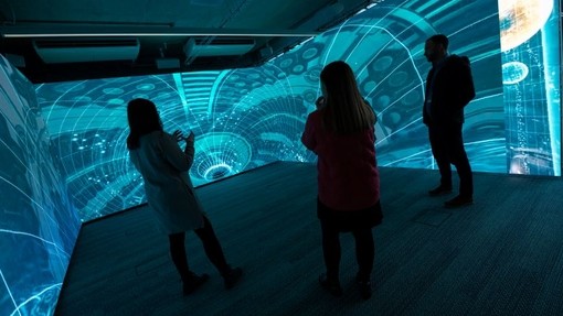 Lecturers standing in one of the immersive rooms