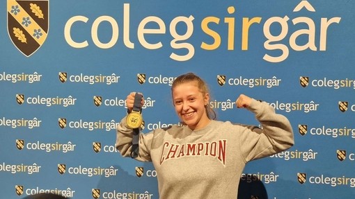 Tamzin is pictured celebrating her gold medal.