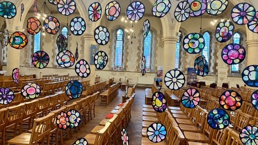 Multi coloured collages hanging in the church