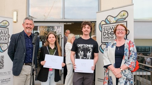 Professor Ian Walsh and Professor Elwen Evans with two of the student award winners standing on the steps outside Dynevor.