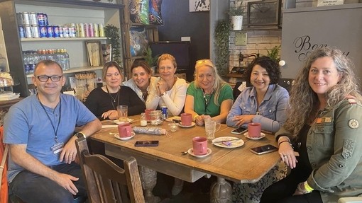 people sitting down smiling at camera