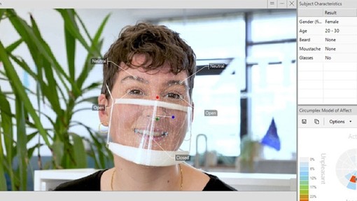 Woman wearing a clear face mask.