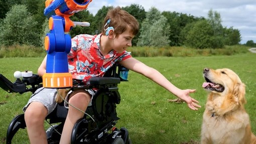 Boy in wheelchair with his golden retriever