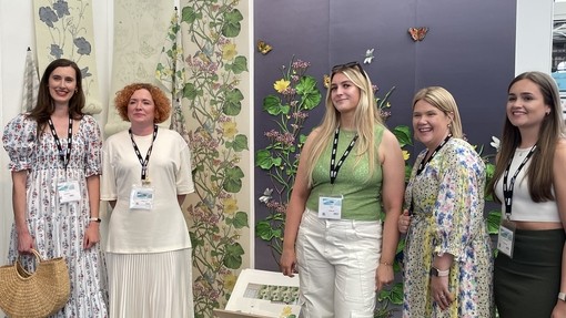 A happy and smiling group celebrating success at New Designers.