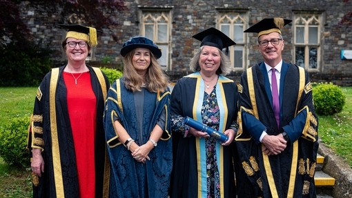 Elwen Evans KC, Sarah Clark, Maria Stedman and Emlyn Dole in their gowns on graduation day in Carmarthen