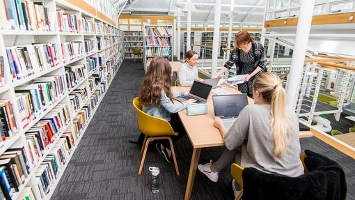Students sitting in Carmarthen library.