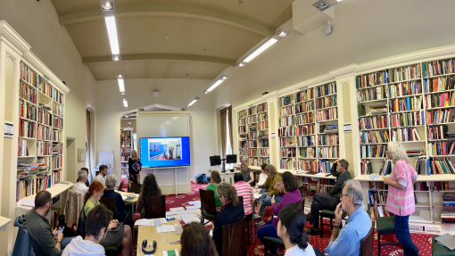 Katie Palmer (Food Sense Wales) making a presentation in the Roderic Bowen Library on the Lampeter campus on "Re-establishing Our Connection with Food Through Veg," stressing the importance of reconnecting communities with sustainable, local food production.