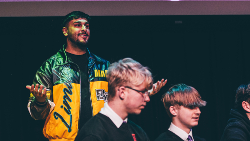 Ameer hosting the event with two students in the foreground
