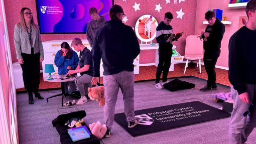 Students in a brightly coloured immersive room.