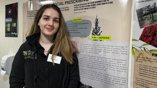 Rhein standing in front of her presentation