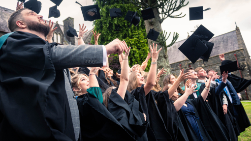 Students graduating throwing their caps into the air