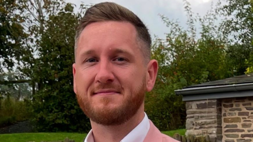 A happy smiling degree apprentice pictured outside.