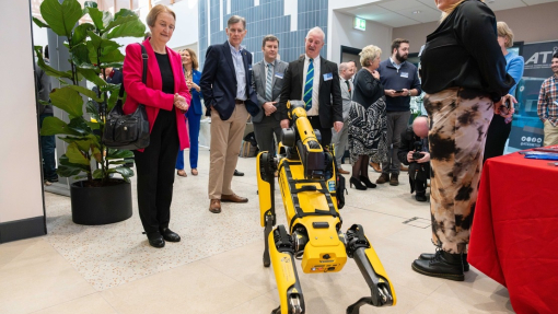 Dame Nia Griffiths and others guests watching dog robbot