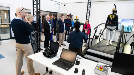 Tour of the new Innovation Matrix building with guests watching somebody walking on a platform