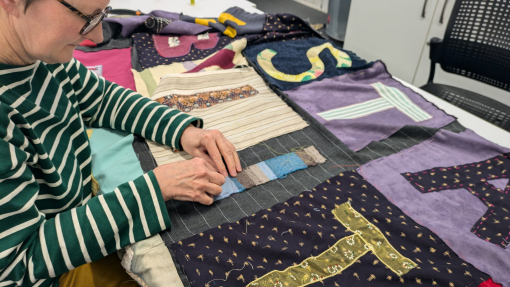 image of lady sewing a banner