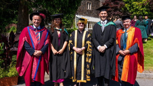 Jeremy Smith, Jennifer Williams, Elwen Evans KC, Markus Schlotbohm, Nick Campion in front of old building on Carmarthen campus