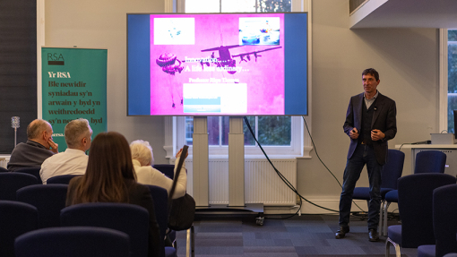 Rhys Thomas making a presentation in front of a crowd