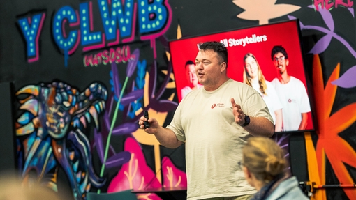Graduate, James Owen speaking on stage