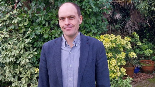 Dr David Callander with hedges in the background